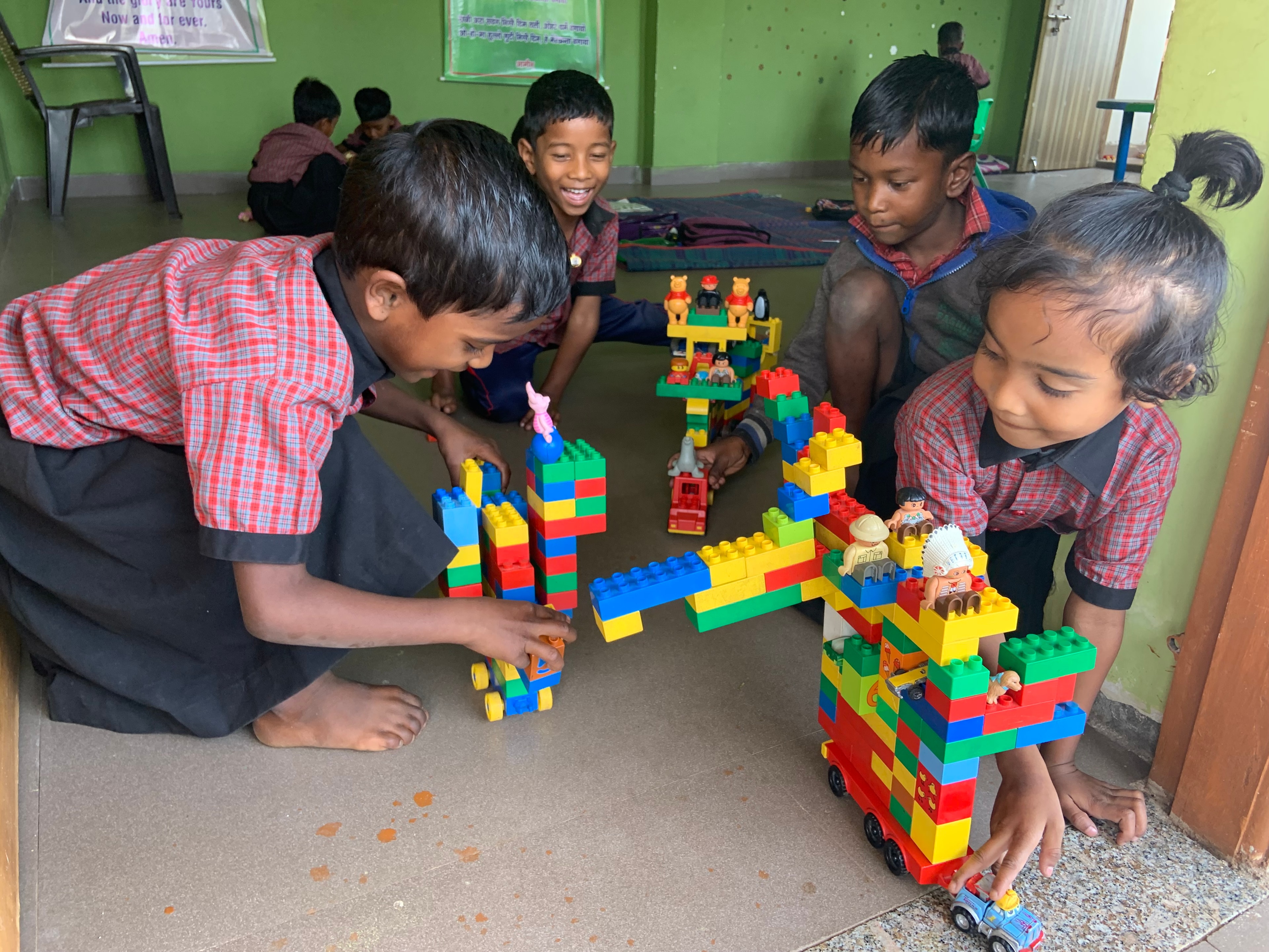 Children building with colourful blocks in classroom