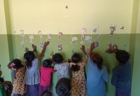 Children learning numbers on a classroom wall