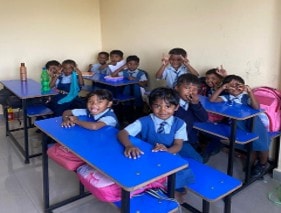 Students seated at desks in a bright classroom