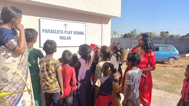 Paracleta Play School Malar signboard with children and teacher